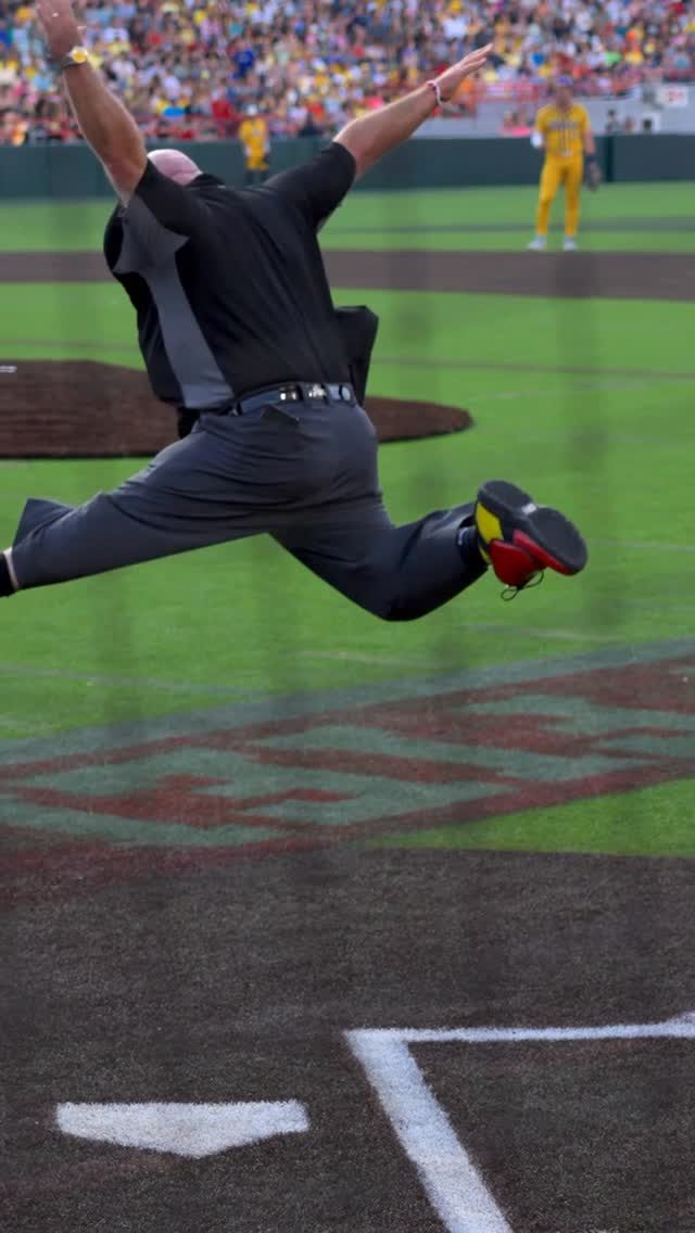 The Dancing Umpire mid-leap behind home plate